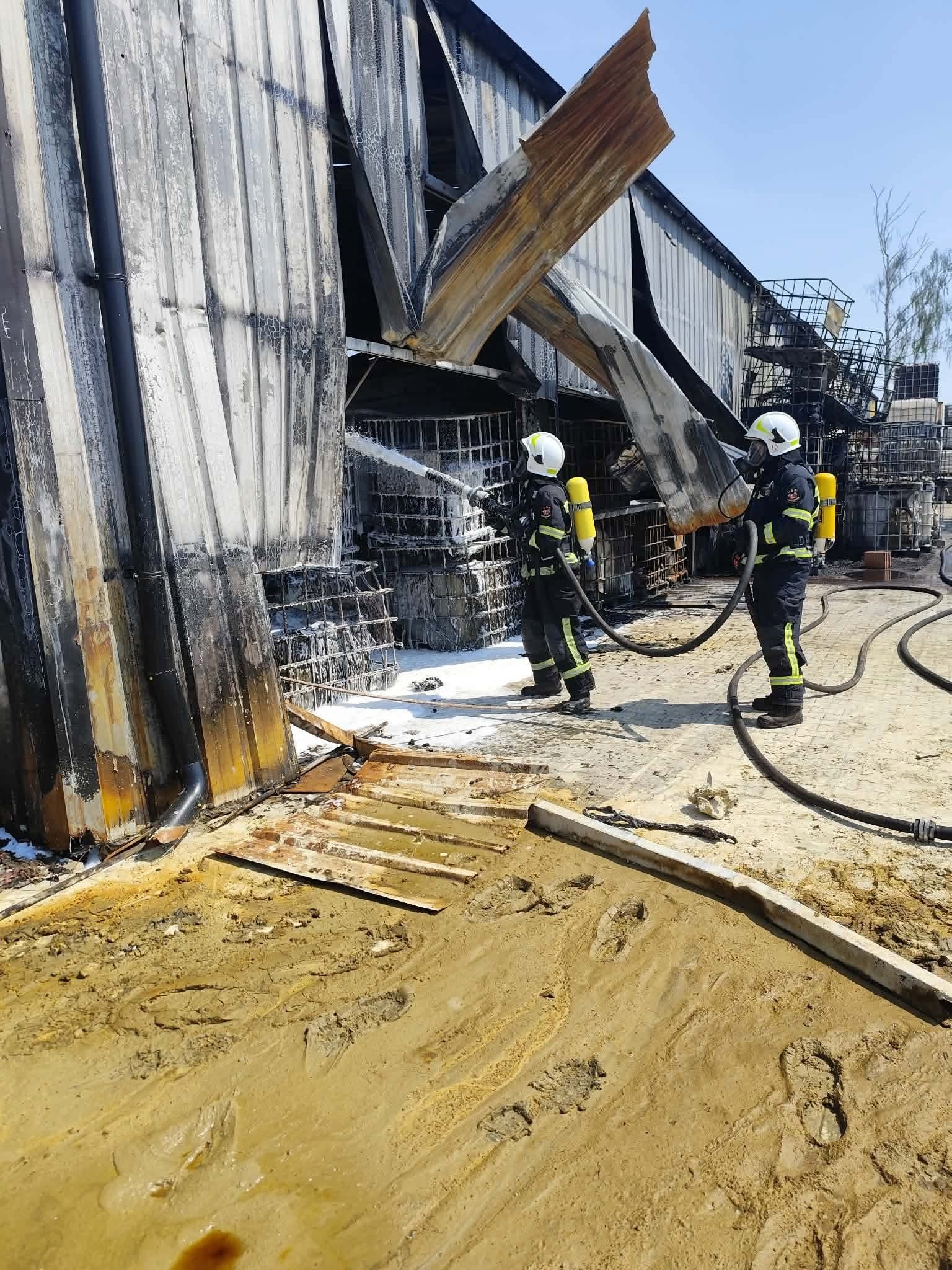 Strażacy podczas dogaszania zarzewi ognia na terenie składowiska odpadów w Mszczonowie