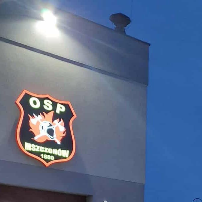 Illuminated OSP Mszczonow emblem on the fire station building