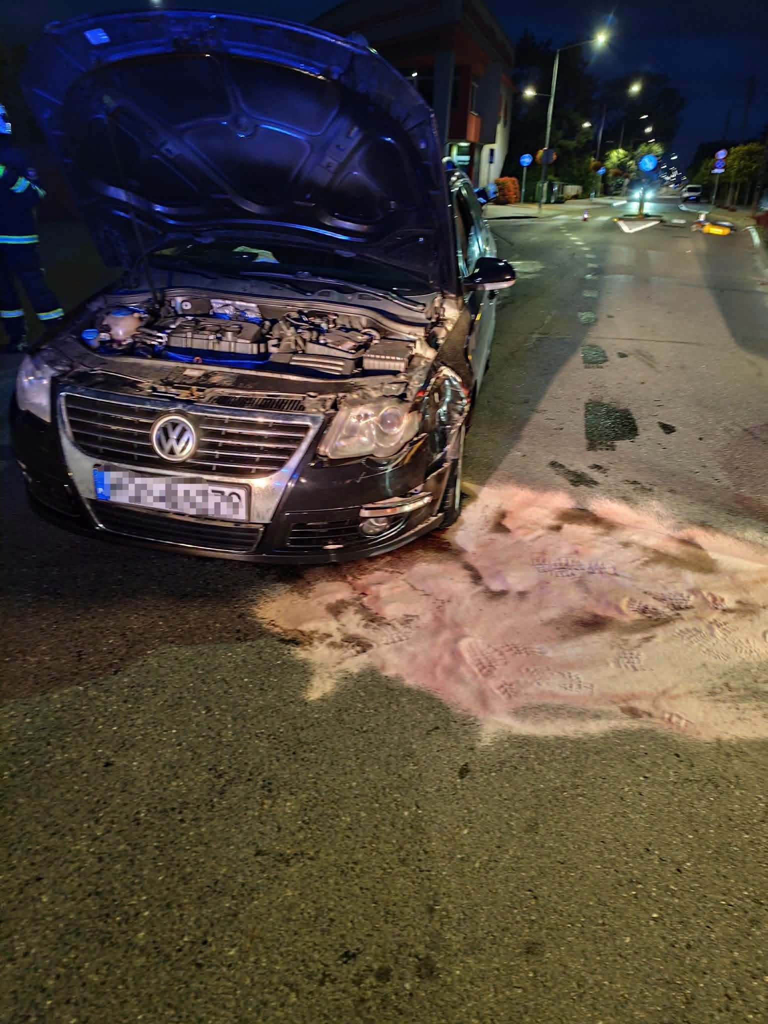 Damaged passenger car after hitting a traffic island