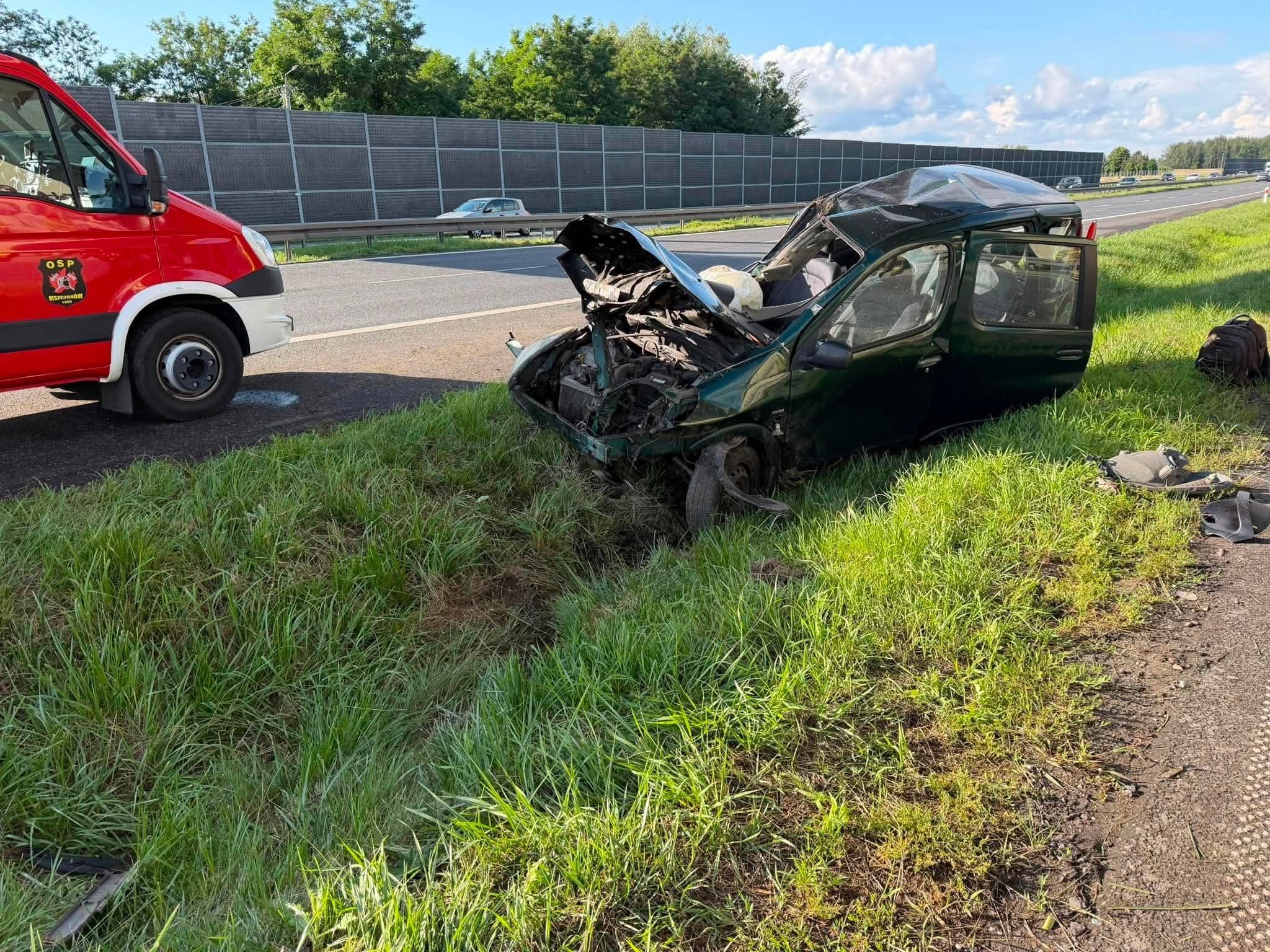 Wrecked passenger car and an OSP Mszczonow vehicle beside the S8 route in Gurba